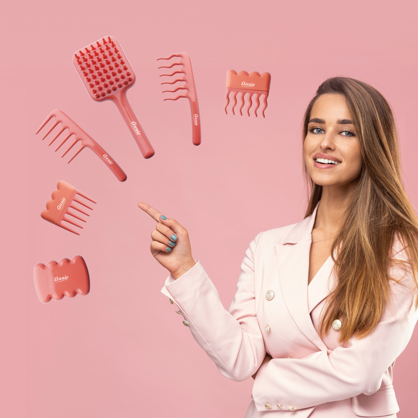 Woman in pink blazer pointing at floating orange Annie Effortless Detangler combs and wavy pik on pink background