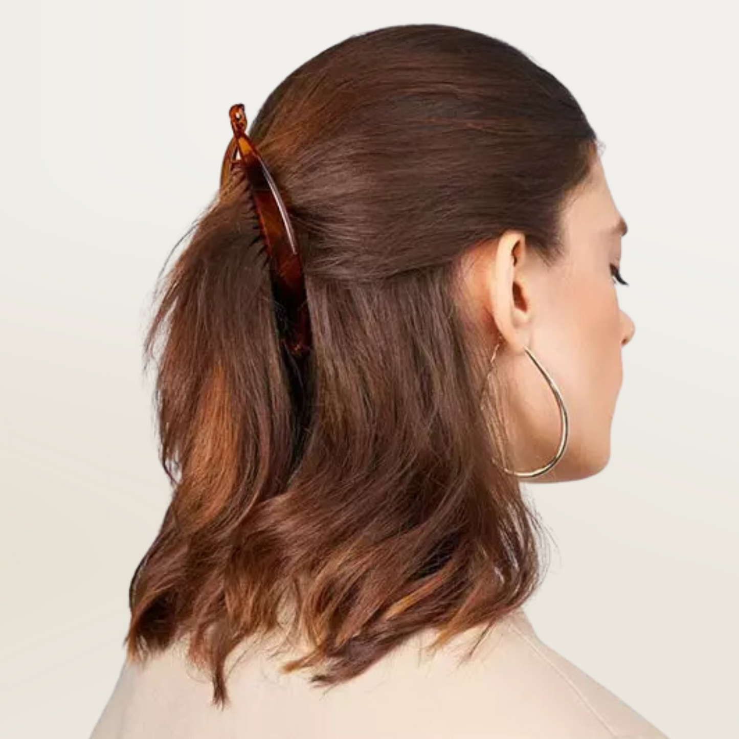 Woman wearing a tortoise shell Annie Banana Fashion Clip 6in, 3 Count Fancy Hair Clip holding half-up hair style.