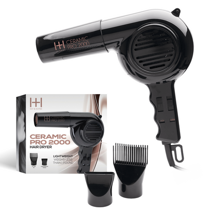 Black hair dryer with packaging and attachments on a white background