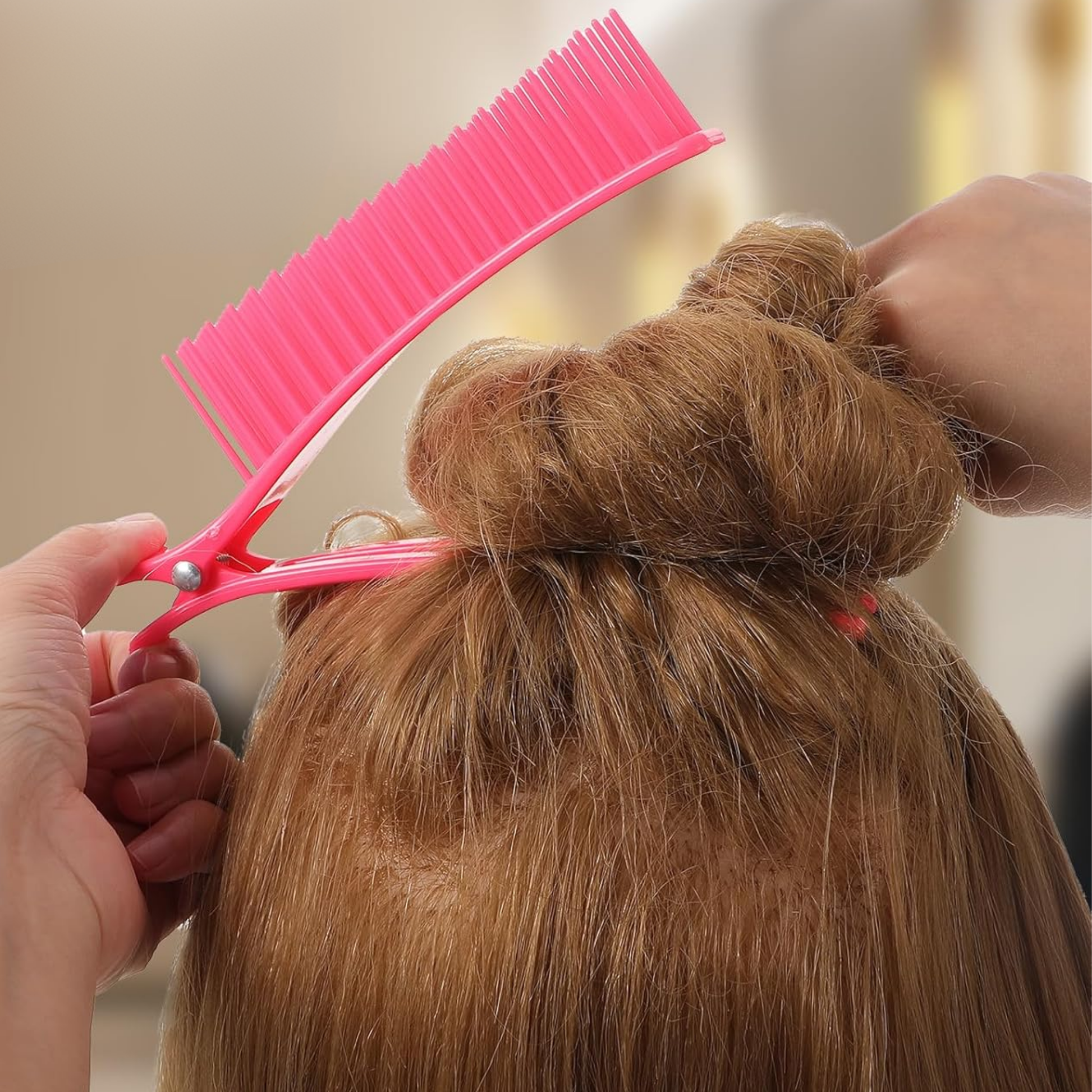 Pink Annie sectioning comb grip clip holding up blonde hair twisted in a bun for styling and sectioning purposes