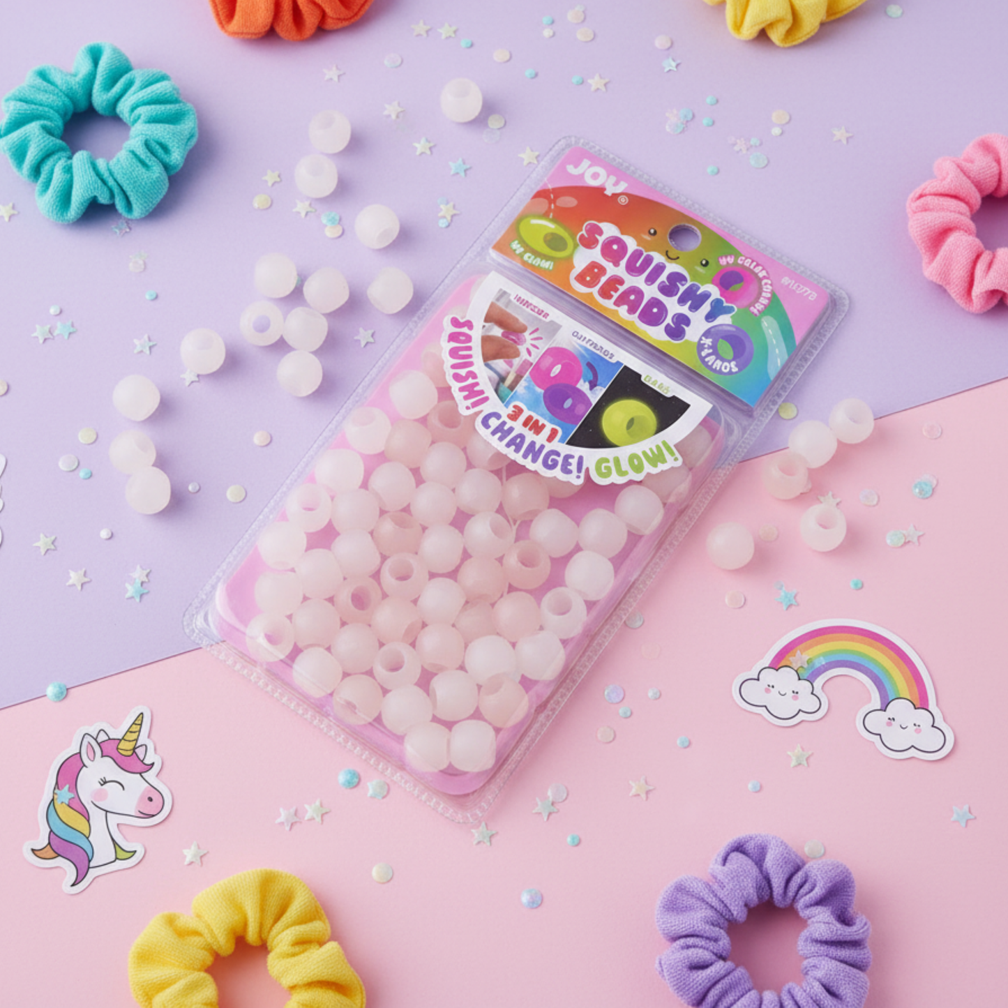 Pack of clear Joy XL round squishy hair beads that glow in the dark, shown with colorful scrunchies and stickers.
