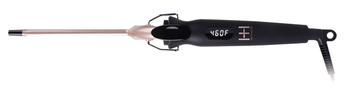 A hair styling tool with a black handle, rose gold barrel, and black cord, shown against a plain white background.