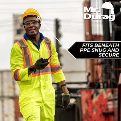 Man wearing bright yellow safety suit and hard hat, demonstrating Mr. Durag Stocking Wave Cap fit beneath PPE gear