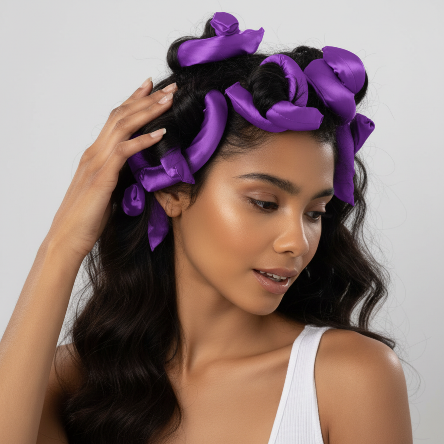 A woman with textured hair styled using purple satin flexi rods, showcasing gentle, snag-free curling designed for natural and multicultural hair types.