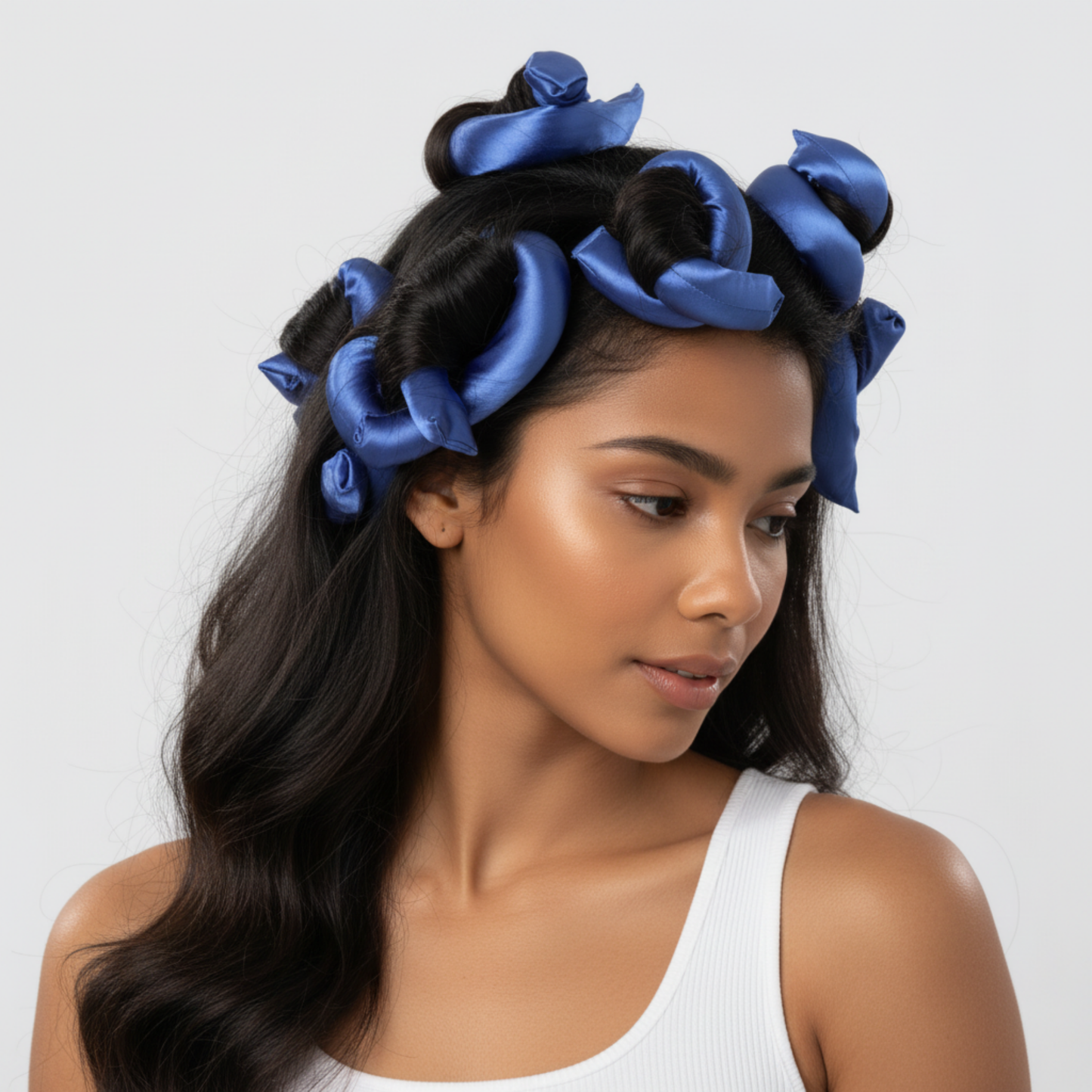 Woman with smooth, textured hair styled using blue silky satin flexi rods designed for gentle, snag-free curling and wave training on natural, multicultural hair.
