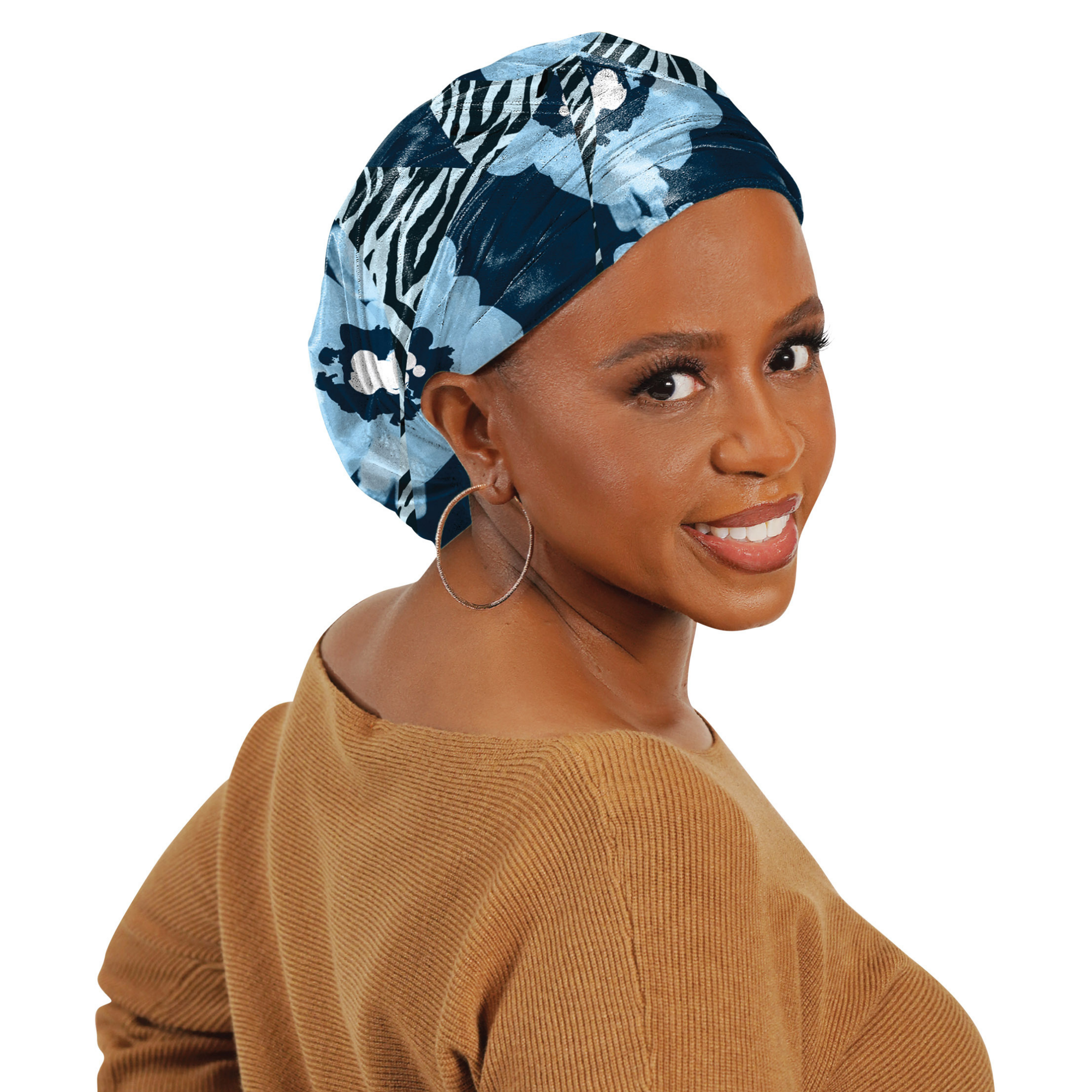 Woman smiling wearing Broadus Collection Floral Zebra head scarf in blue and black with hoop earrings and brown sweater