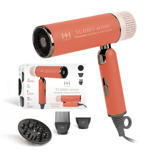 Orange hair dryer with attachments and packaging on a white background