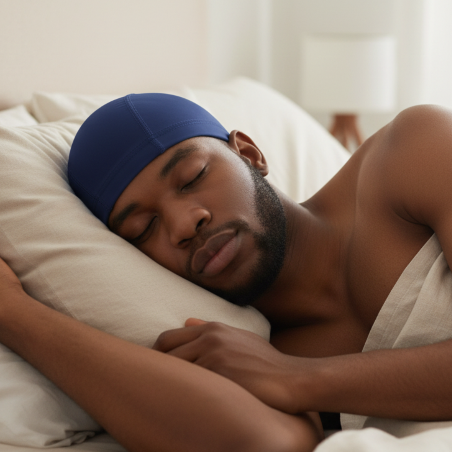 A man peacefully sleeping wearing Mr. Durag Spandex Dome Cap, 1 Count, Assorted Colors in navy blue, featuring smooth, elastic spandex material designed for comfortable hair protection and wave preservation.