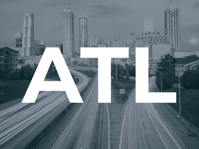 Black and white cityscape of Atlanta with highway light trails and large white ATL text overlay