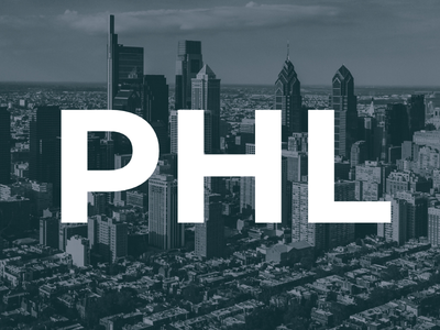 Aerial view of a city skyline with tall buildings and large white letters "PHL" overlaying the image