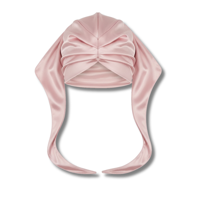Pink satin Ms. Remi Effortless Turban Scarf with closed top and twisted front detail on white background