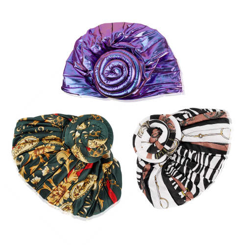 Three colorful patterned satin hair turbans arranged on a white background with visible folds and texture