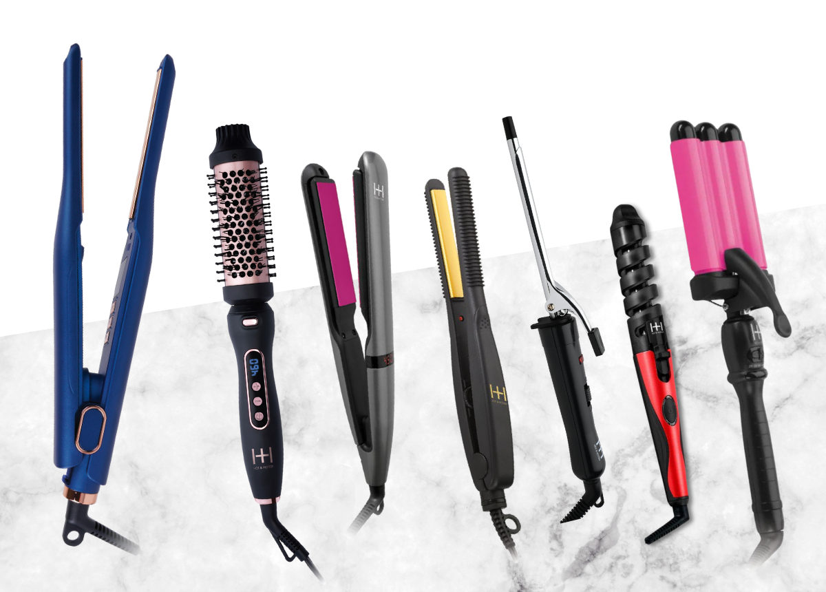 Array of various hairstyling tools including straighteners, curling irons, and wavers on a white marble surface