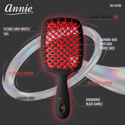 Black paddle detangling brush with an ergonomic handle, flexible gray and red bristle tips, a red cushioned base, diamond-vent open grid design, and hanging hook for textured hair care.