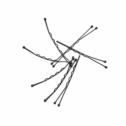 Annie Curved Jumbo Pins 2 3/4 Inch, 80 Count, Black arranged on a white surface showcasing curved metal pins with rounded tips designed for secure, professional hairstyling.