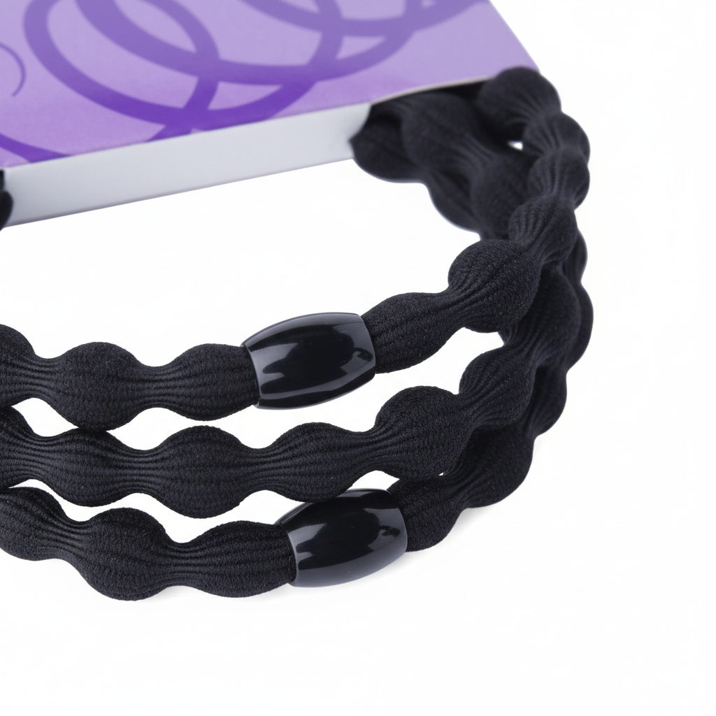 Three black elastic hair ties with wavy texture and glossy black beads, designed to provide a secure, snag-free hold for textured and natural hair styles.