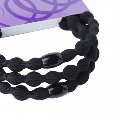 Three black elastic hair ties with wavy texture and glossy black beads, designed to provide a secure, snag-free hold for textured and natural hair styles.