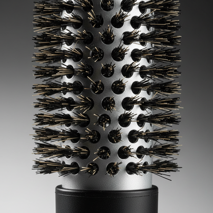 Close-up of a black thermal round curling brush barrel with densely packed boar and nylon bristles, designed for styling and smoothing textured hair with heat.