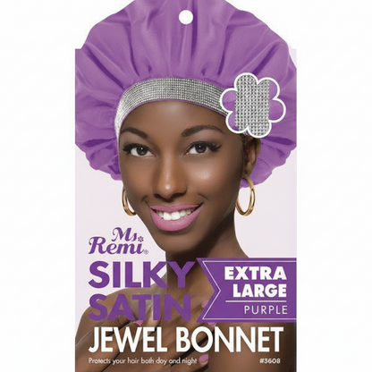 Smiling woman modeling an extra-large purple satin bonnet with a sparkling rhinestone jewel band, designed to protect textured hair day and night with gentle, silky comfort.