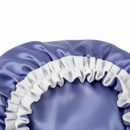 Close-up of a medium-sized purple satin bonnet with a white elastic band, designed to gently protect and preserve textured hair with a smooth, comfortable fit.