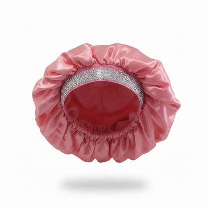 X-large pink satin bonnet featuring a sparkling rhinestone band and gathered elastic edge, crafted to protect and maintain textured hair overnight or during styling.