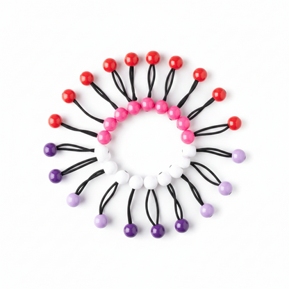 Assorted colored twin bead ponytailers arranged in a circular pattern, designed for secure, snag-free hold on textured and multicultural hair.