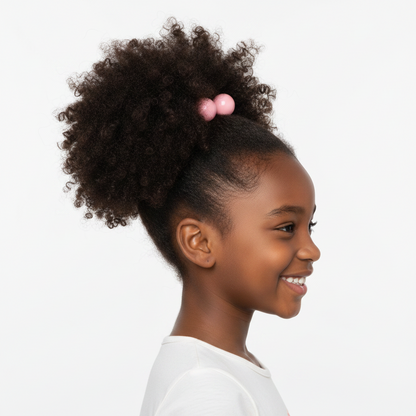 Smiling young girl with textured natural hair styled in a high puff secured with blush-colored twin bead hair accessories designed for gentle hold on multicultural hair.