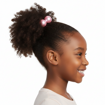 Young girl with textured natural hair styled in a ponytail secured with shiny pink twin bead hair accessories designed for multicultural hair.