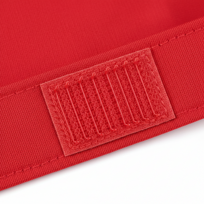 Close-up of a red synthetic spandex band featuring a durable hook-and-loop fastener designed for adjustable, snug, and comfortable hold on textured and multicultural hair styles.