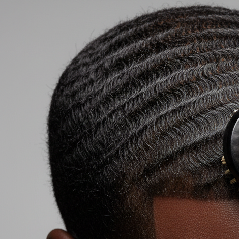 Close-up of textured natural hair styled into defined waves using a black soft boar bristle brush designed for wave training and hair pattern enhancement.