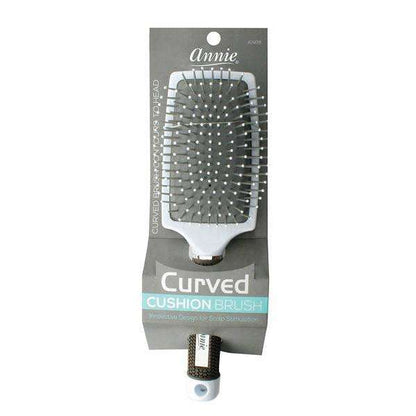 Silver curved cushion hairbrush with flexible ball-tipped bristles on a ventilated base, designed by Annie for comfortable detangling and scalp stimulation on textured hair.