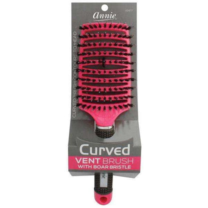 Bright pink curved vent brush featuring densely packed 100% boar bristles and sturdy handle for efficient airflow and smooth styling of textured and natural hair.