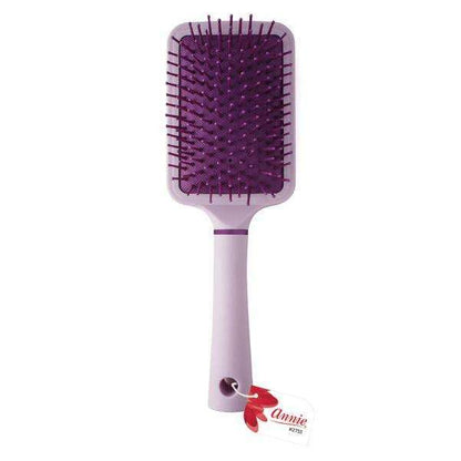 Purple cushion paddle brush with nylon bristles and ergonomic handle designed by Annie International for gentle detangling and smoothing of textured and multicultural hair.