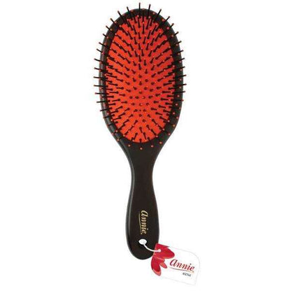 Oval wooden hairbrush with a red cushion base and black nylon bristles, designed by Annie International for gentle detangling and smoothing of textured hair.