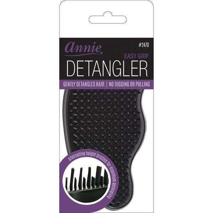 Black detangling brush with ergonomic curved handle and flexible bristles of varying heights designed for gentle, snag-free detangling of textured and multicultural hair.