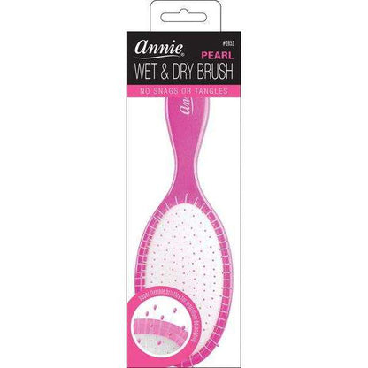 Magenta oval detangling brush with pearl-tipped flexible bristles and cushioned base, engineered by Annie for smooth styling on wet or dry textured and multicultural hair.
