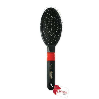 Black wire cushion brush with ball-tipped bristles and red grip, designed by Annie for gentle detangling and styling of textured, natural hair.